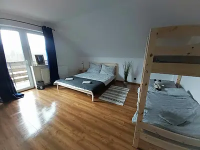 a bedroom with a bunk bed and a ladder at Sarnie wzgórze Sucha Beskidzka sauna jacuzzi in Kuków
