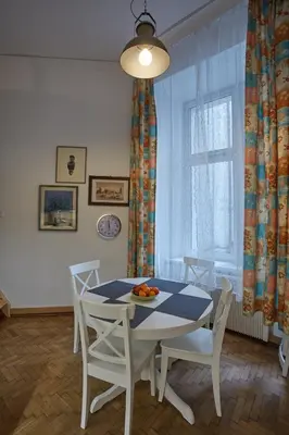 a dining room with a table and chairs and a window at Stylish Apartment Kraków - Old Town in Kraków
