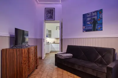a living room with a couch and a television at Stylish Apartment Kraków - Old Town in Kraków