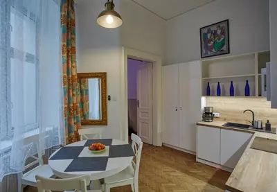 a kitchen and dining room with a table and chairs at Stylish Apartment Kraków - Old Town in Kraków
