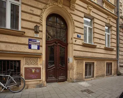 a bike parked in front of a building with a door at Stylish Apartment Kraków - Old Town in Kraków