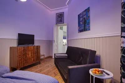 a living room with a couch and a tv at Stylish Apartment Kraków - Old Town in Kraków