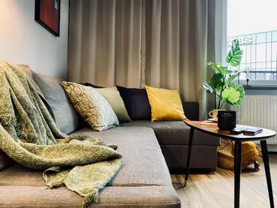 a living room with a couch and a table at Apartment next to Cracow Eye, Vistula Boulevards in Kraków