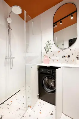 a bathroom with a washing machine and a mirror at Apartment next to Cracow Eye, Vistula Boulevards in Kraków