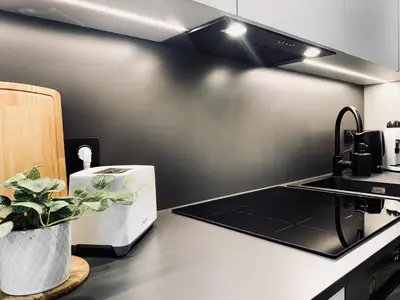 a kitchen with a sink and a stove top oven at Apartment next to Cracow Eye, Vistula Boulevards in Kraków
