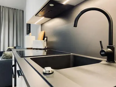 a kitchen with a sink and a faucet at Apartment next to Cracow Eye, Vistula Boulevards in Kraków