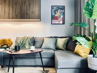 a living room with a couch and a table at Apartment next to Cracow Eye, Vistula Boulevards in Kraków
