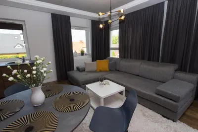 a living room with a couch and a table at Lenzo Apartments Wieliczka in Wieliczka