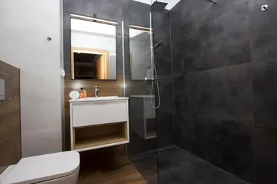 a bathroom with a shower with a toilet and a sink at Lenzo Apartments Wieliczka in Wieliczka