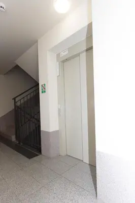 a hallway with a door in a building at Lenzo Apartments Wieliczka in Wieliczka