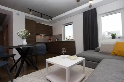 a living room with a couch and a table at Lenzo Apartments Wieliczka in Wieliczka