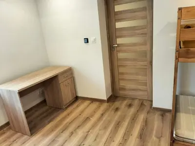 a room with a wooden desk and a door at Zielony Zakątek in Złota
