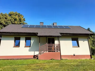 a house with solar panels on the roof at Zielony Zakątek in Złota