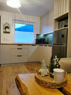 a kitchen with a table with a basket and a window at JAWORNICA HOUSE domek z pięknym widokiem in Targanice