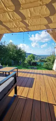 a wooden deck with a table and benches on it at JAWORNICA HOUSE domek z pięknym widokiem in Targanice