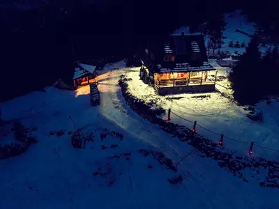 an aerial view of a building in the snow at night at Domek w Górach- Bacówka u Dudka in Nowy Targ