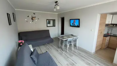 a living room with a couch and a table at Apartament Cichy Kącik Zator tylko 1km od ENERGYLANDII in Zator