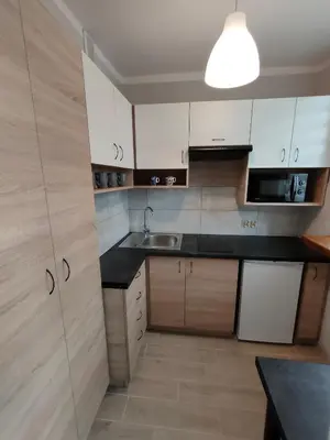 a kitchen with white cabinets and a sink at Apartament Cichy Kącik Zator tylko 1km od ENERGYLANDII in Zator