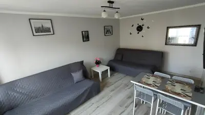 a living room with a couch and a table at Apartament Cichy Kącik Zator tylko 1km od ENERGYLANDII in Zator