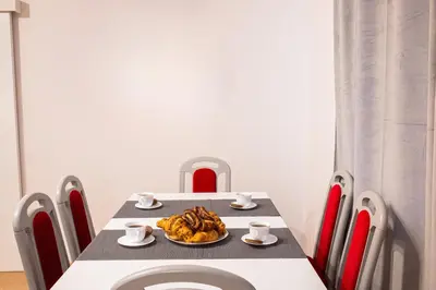 a dining room table with a plate of food on it at Cracowapart Ignacio A in Kraków