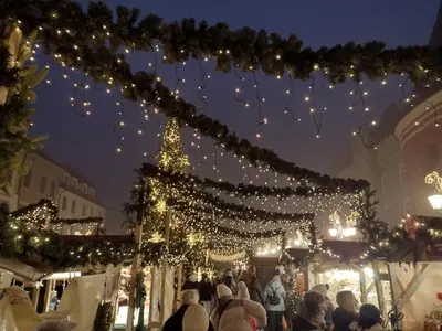 people walking around a christmas market with lights at Cracowapart Ignacio A in Kraków