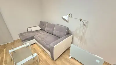 a couch in a living room with a lamp at Topolowa Apartament z klimatem- Topolowa/Rynek/PKP in Kraków