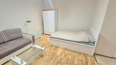 a small bedroom with a bed and a couch at Topolowa Apartament z klimatem- Topolowa/Rynek/PKP in Kraków