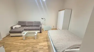 a living room with a couch and a bed at Topolowa Apartament z klimatem- Topolowa/Rynek/PKP in Kraków