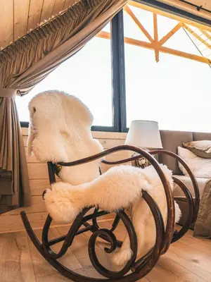 a dining room with a wooden table and chairs at Osada Janosika Jacuzzi Drewniany Domek Na Odludziu in Klikuszowa