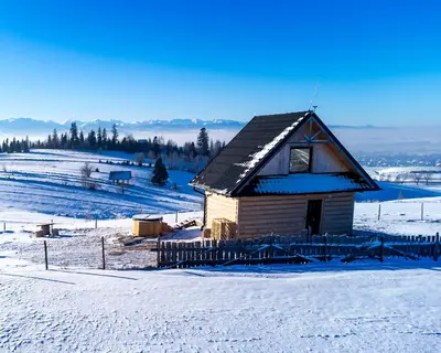 an aerial view of a snowy field with a bridge at Osada Janosika Jacuzzi Drewniany Domek Na Odludziu in Klikuszowa