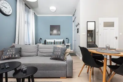 a living room with a couch and a table at City of the Kings - Mosaic Apartment in Kraków