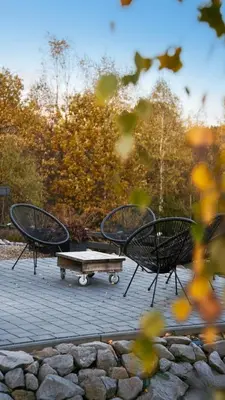 two chairs and a table and a bench in a park at Beskidzki Reset in Budzów