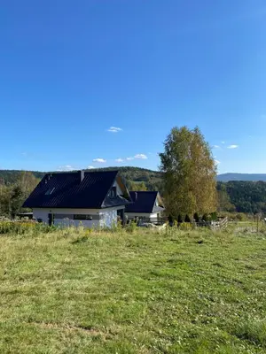 a house with solar panels on it in a field at Beskidzki Reset in Budzów