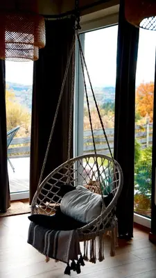 a hanging hammock in a room with a window at Beskidzki Reset in Budzów