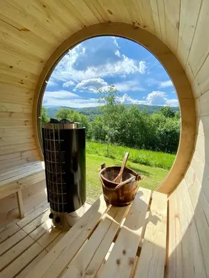 an inside view of a wooden cabin with a window at Czill-Lokum- klimatyczna chata w Beskidach z balią i sauną in Maków Podhalański