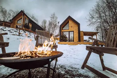 a fire pit in the snow in front of a cabin at Czill-Lokum- klimatyczna chata w Beskidach z balią i sauną in Maków Podhalański