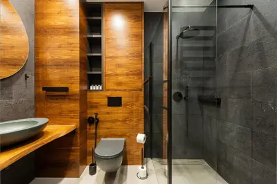 a bathroom with a shower and a toilet and a sink at Central Apartments by Bed&Bath in Kraków