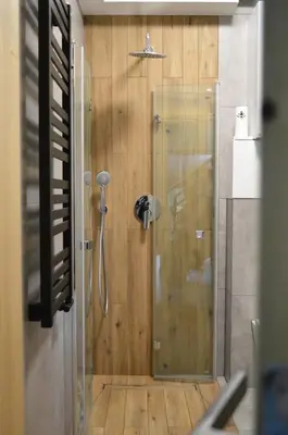 a shower with a glass door in a bathroom at Zacna Chata domek z jacuzzi na wyłączność in Półrzeczki
