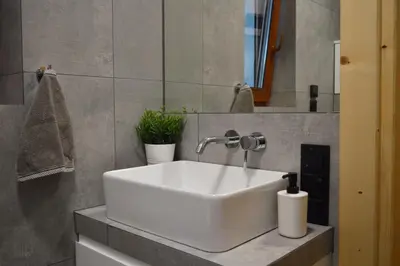 a white sink in a bathroom with a mirror at Zacna Chata domek z jacuzzi na wyłączność in Półrzeczki