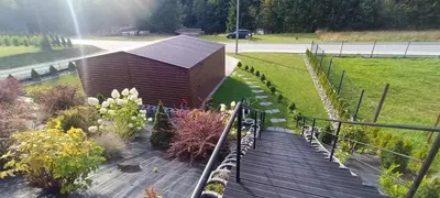 a wooden building sitting on top of a walkway at Apartamenty Obidowa in Obidowa