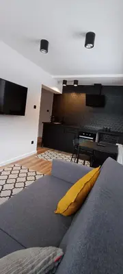 a room with a bed with a yellow pillow at Apartamenty Obidowa in Obidowa