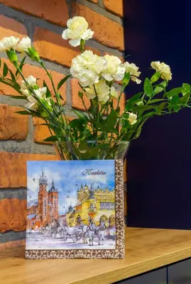 a vase filled with white flowers sitting on a table at Apartamenty U Pana Cogito in Kraków