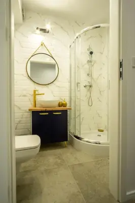 a bathroom with a sink toilet and a shower at Apartamenty U Pana Cogito in Kraków