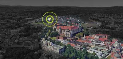 a city with a building with a green circle on it at Apartamenty U Pana Cogito in Kraków