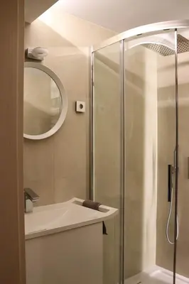 a bathroom with a shower with a sink and a mirror at Beskid Rose & SPA in Słopnice