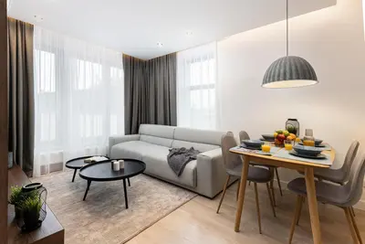 a living room with a couch and a table at HOUSEHOST Apartment: Miodowa 42/30 Street in Kraków