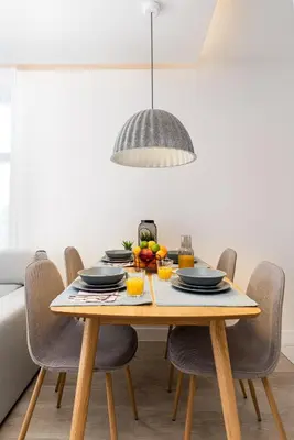 a dining room table with a bowl of fruit on it at HOUSEHOST Apartment: Miodowa 42/30 Street in Kraków
