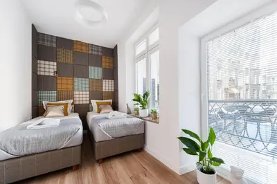 a bedroom with two beds and a window at Luxury SPA Apartment Old Town Krakow in Kraków