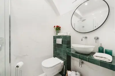 a bathroom with a toilet and a sink and a mirror at Luxury SPA Apartment Old Town Krakow in Kraków
