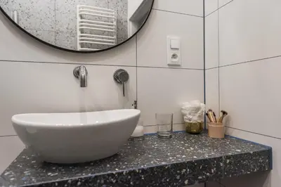 a bathroom with a sink and a mirror at Luxury SPA Apartment Old Town Krakow in Kraków